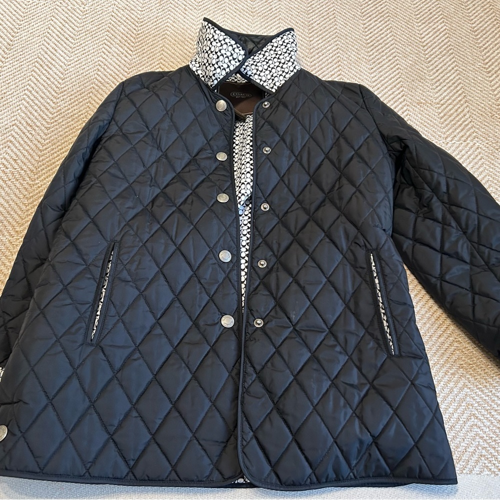 Coach cost with logo visible. It’s like new. It’s a small but feels like medium.